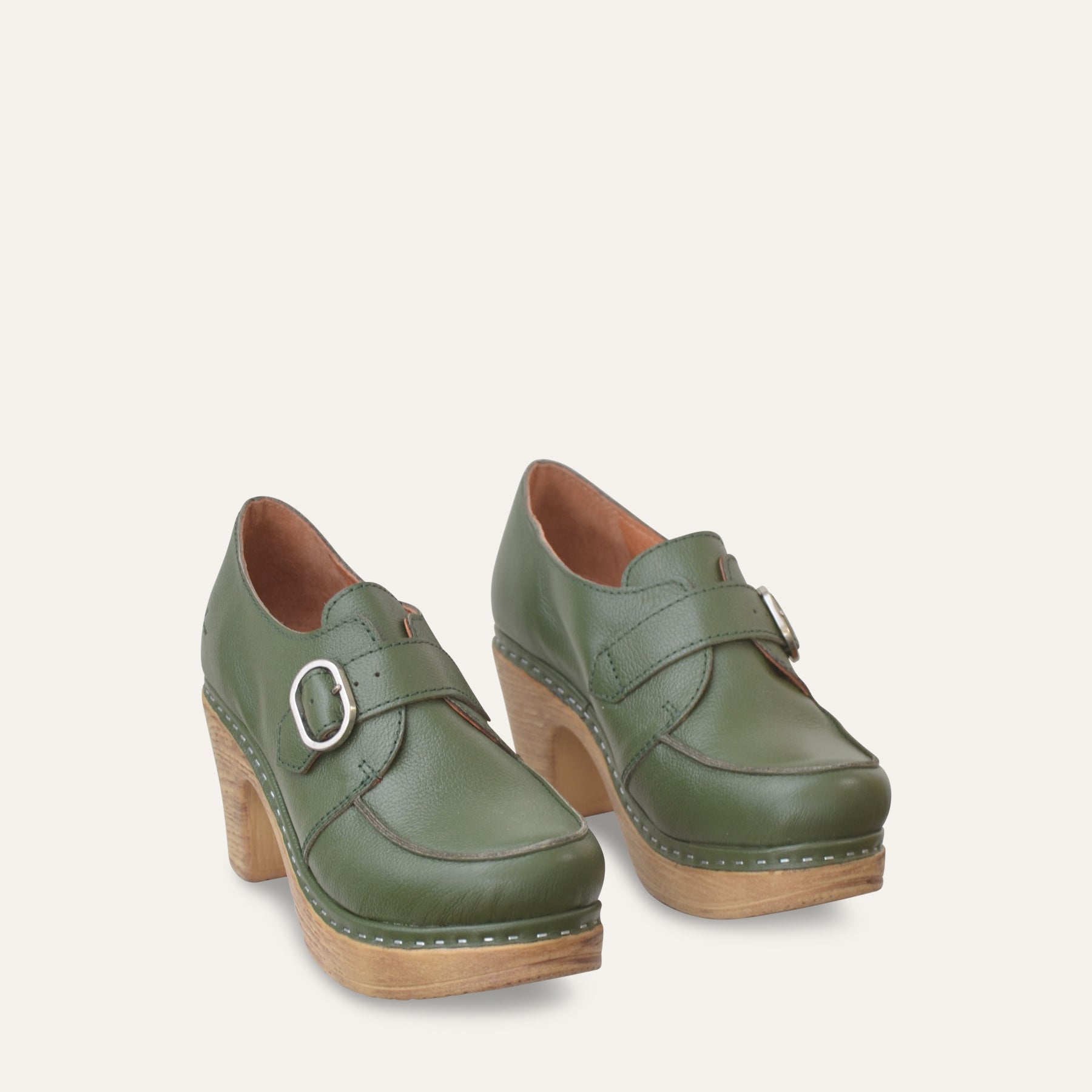 Green shoes with wood effect sole on a light gray background