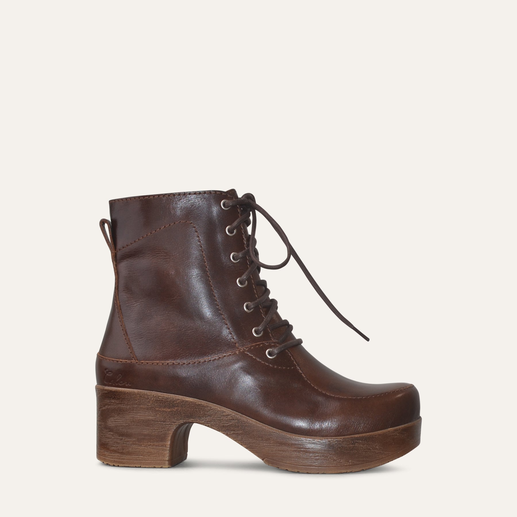 Brown leather lace-up boot with a platform sole on a white background