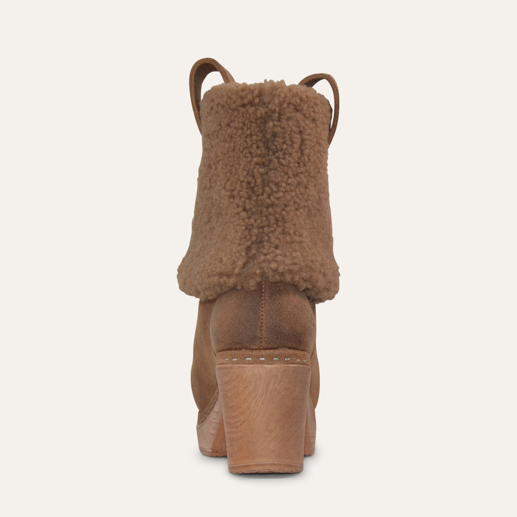 Brown boot with fuzzy top on a white background