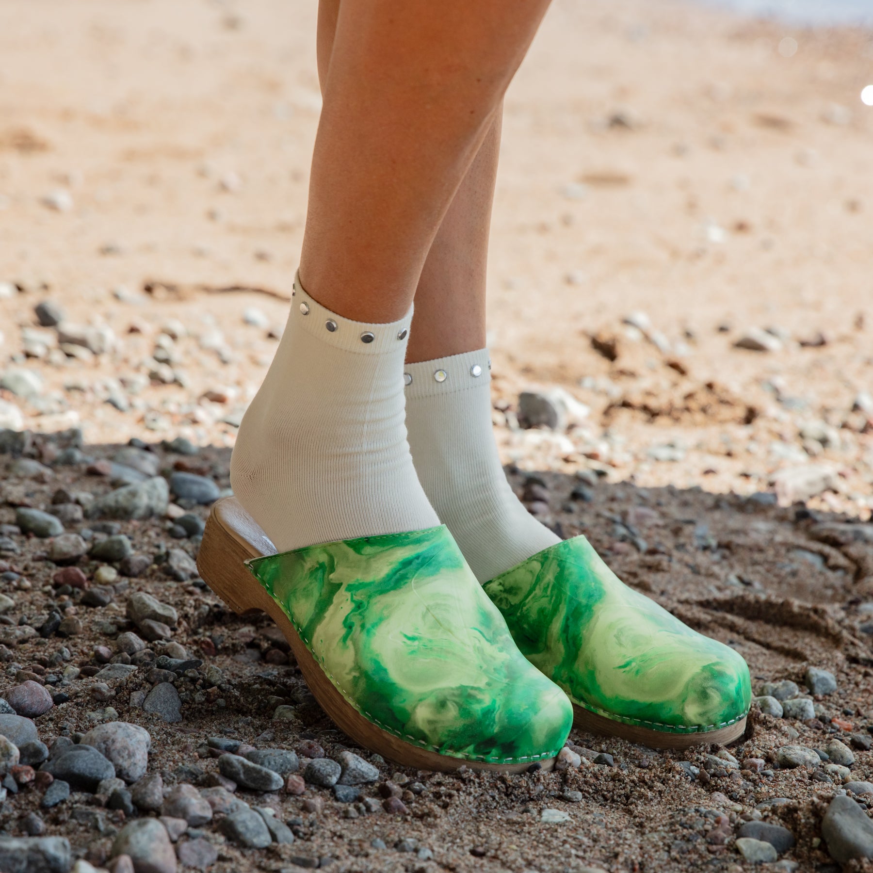 Helena shades of green leather clogs on model Calou