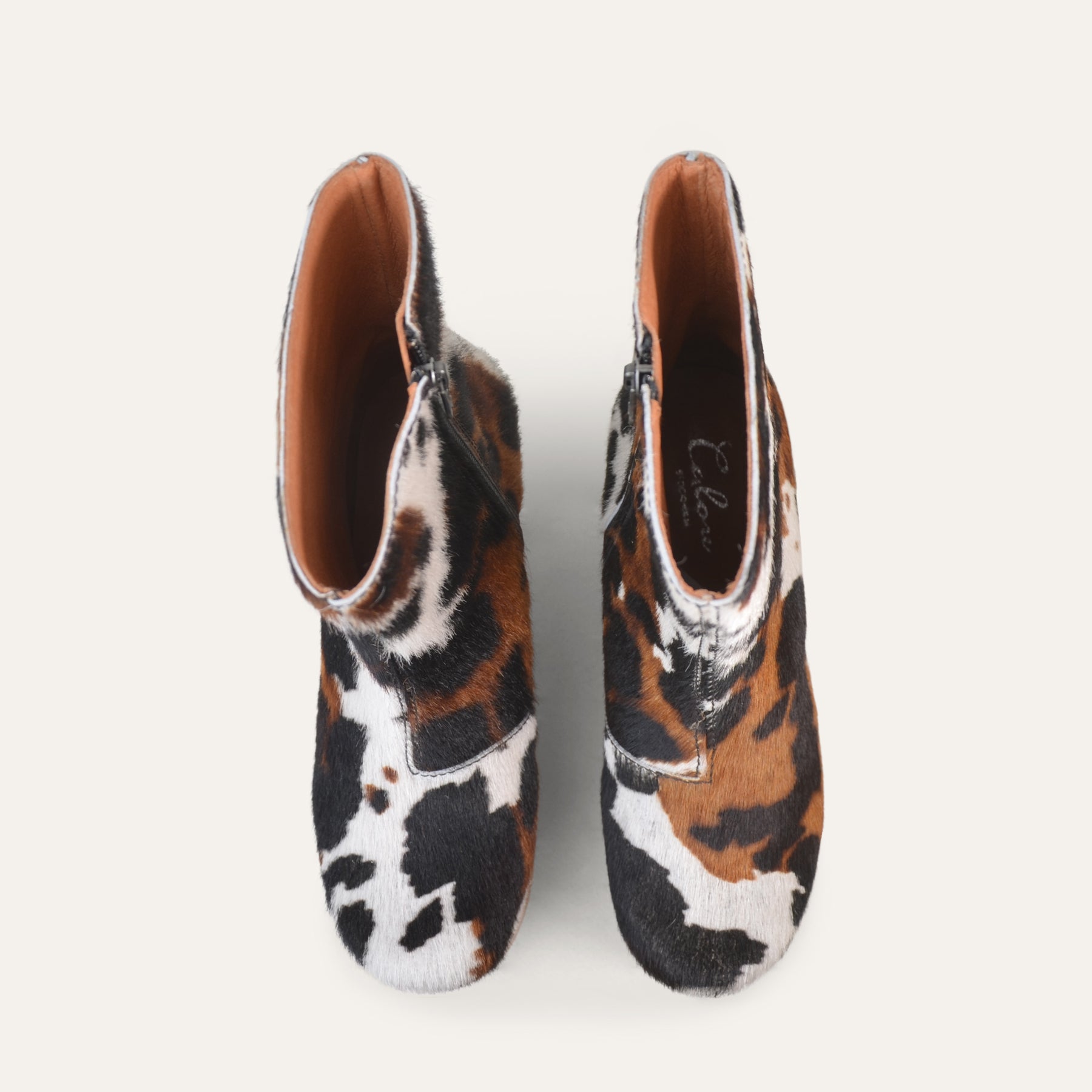 Pair of animal print shoes on a white background