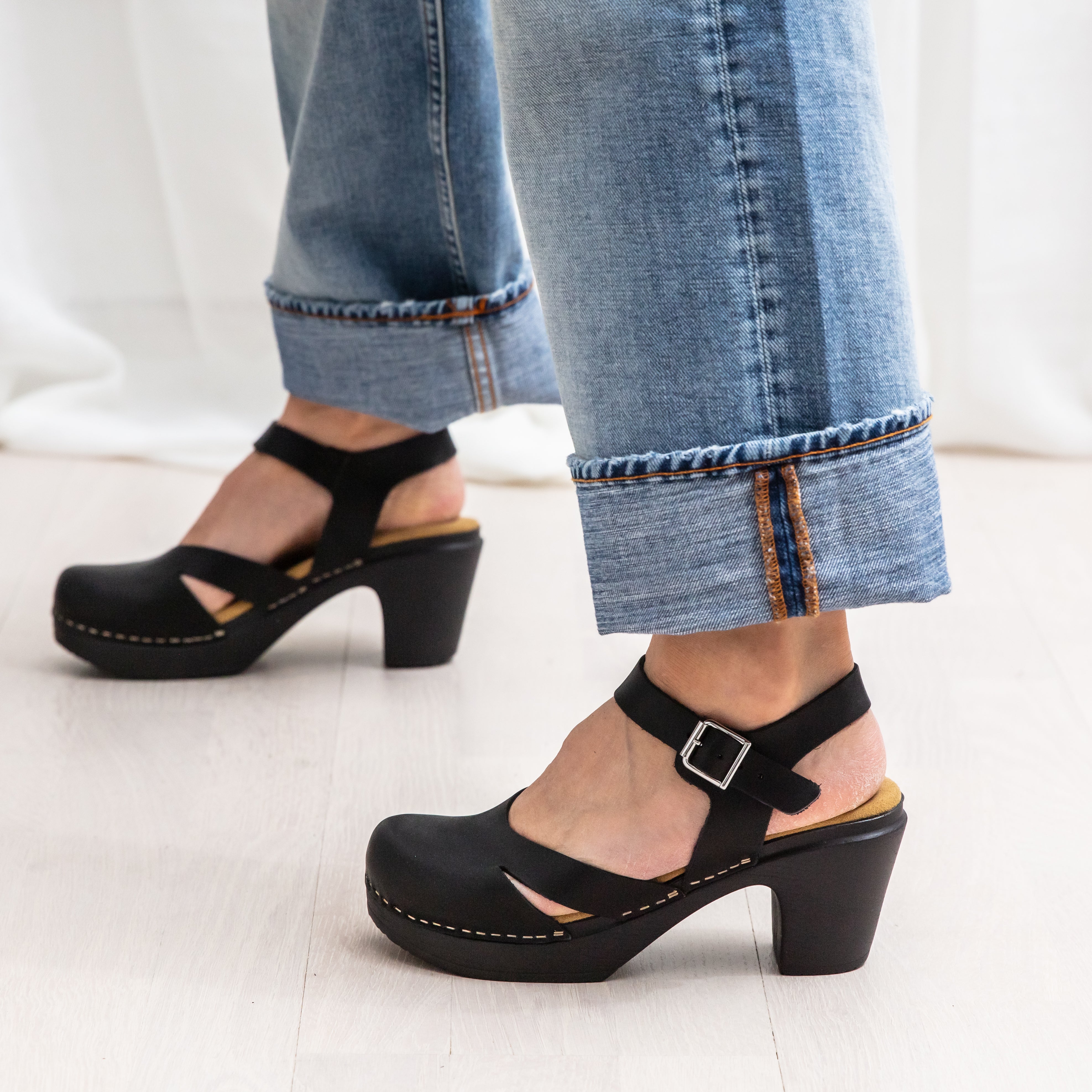 Penny black leather clogs on model calou stockholm