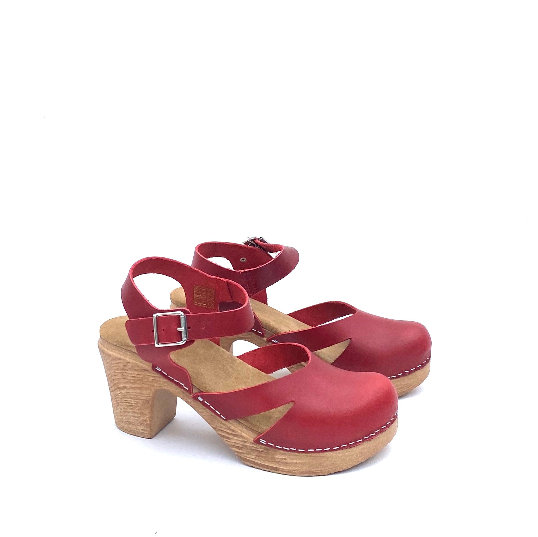 Red clogs with wood-look sole on a white background