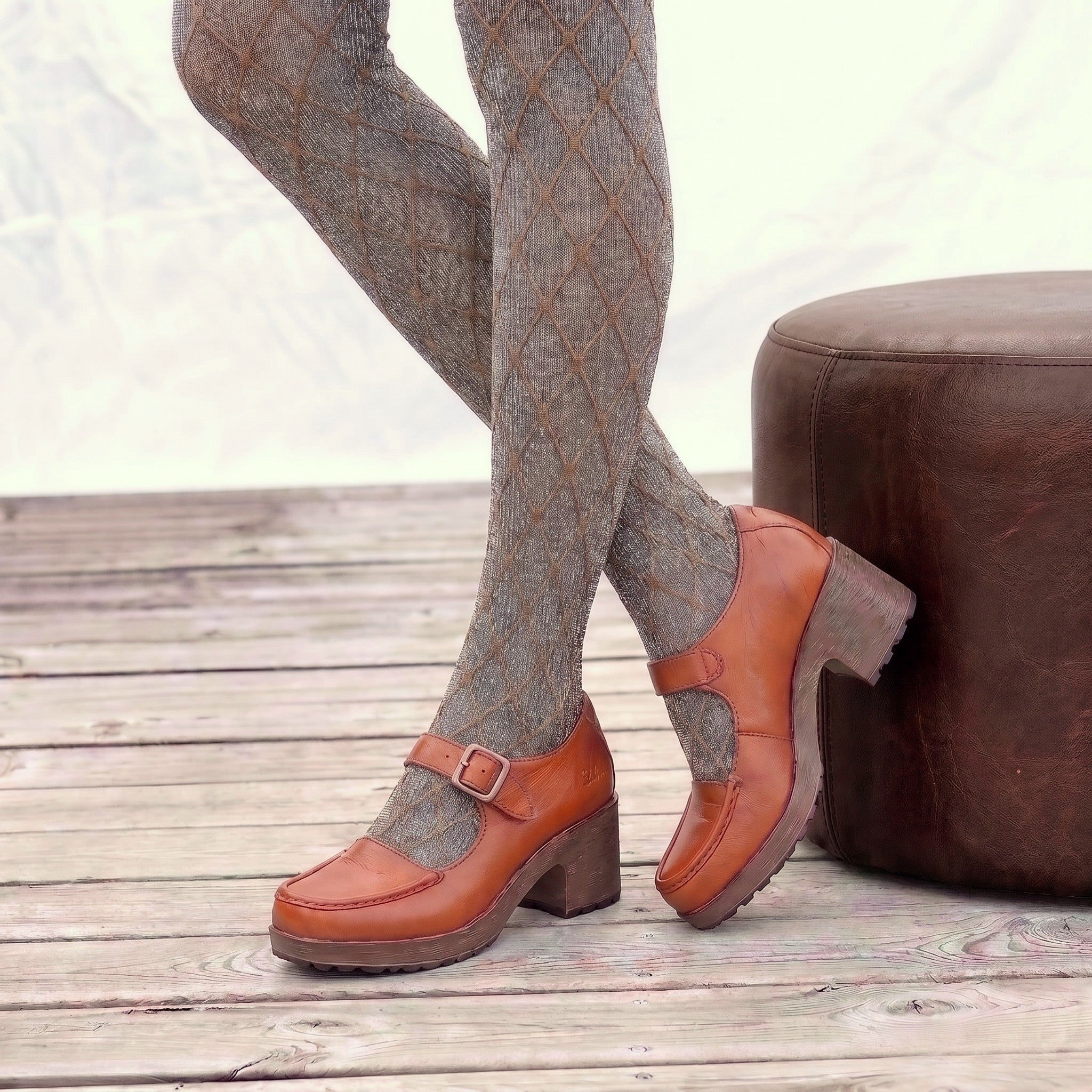 !wa Rust leather Mary Jane clog with a buckle strap, wood-look heel, and soft, flexible, cushioned sole, styled with patterned tights