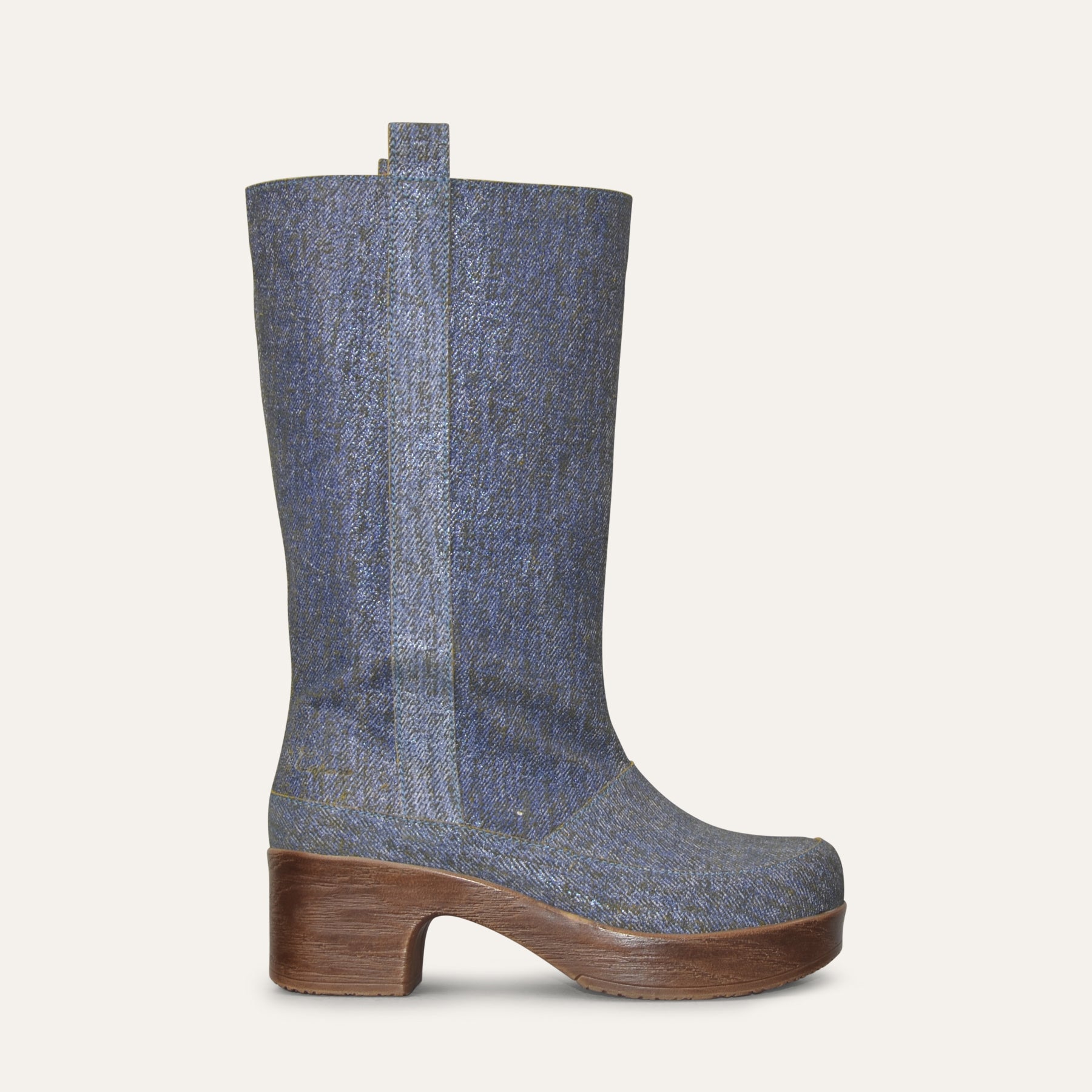 Blue denim boot with soft wood-like sole on a white background