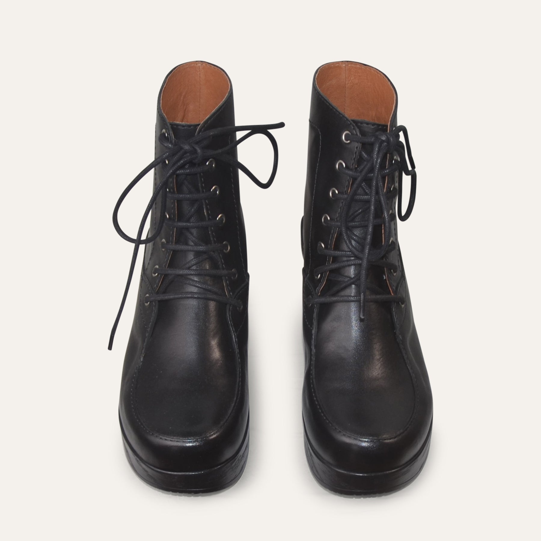 Pair of black leather boots on a white background
