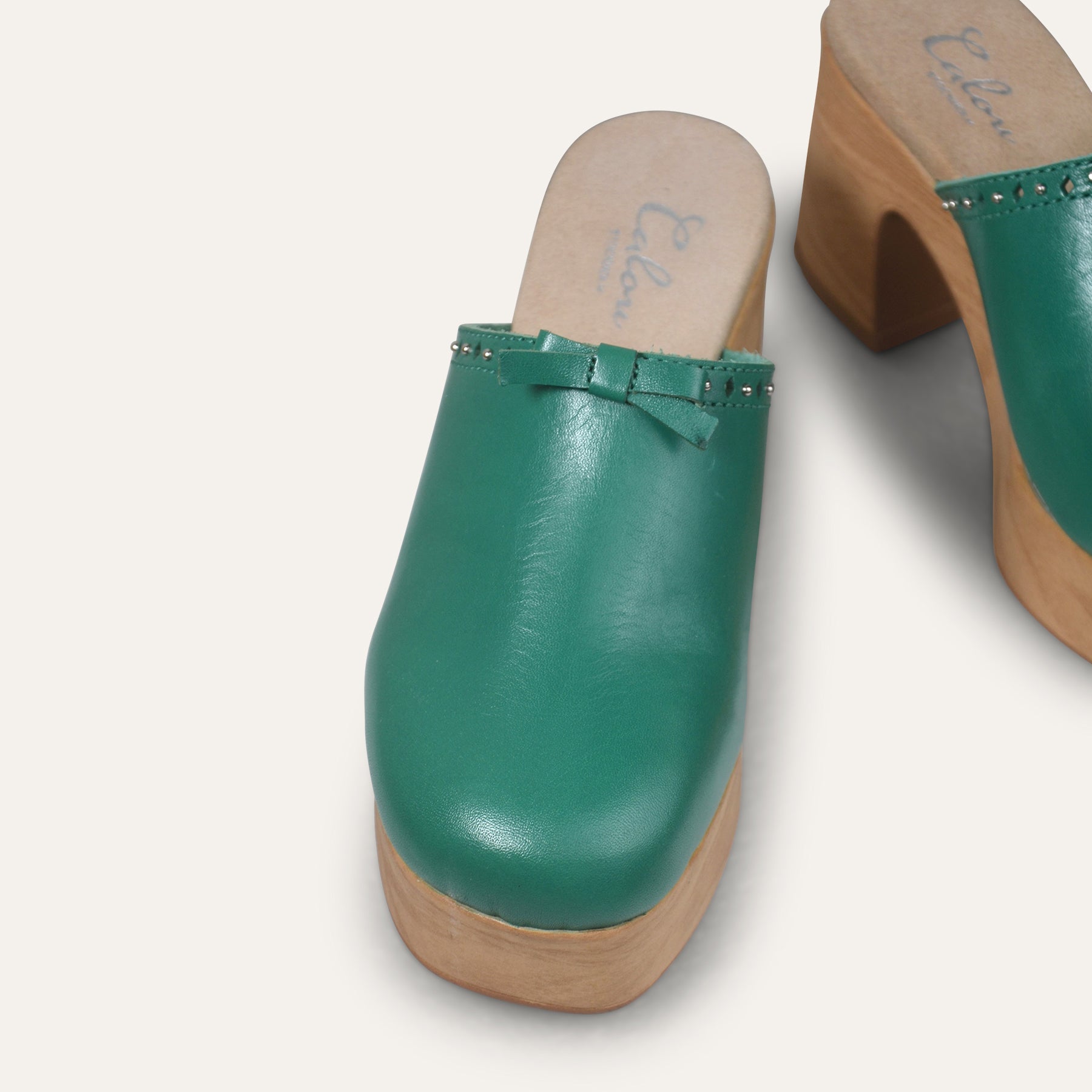 Calou Green leather clogs with studs and bow detail on flexible soles 