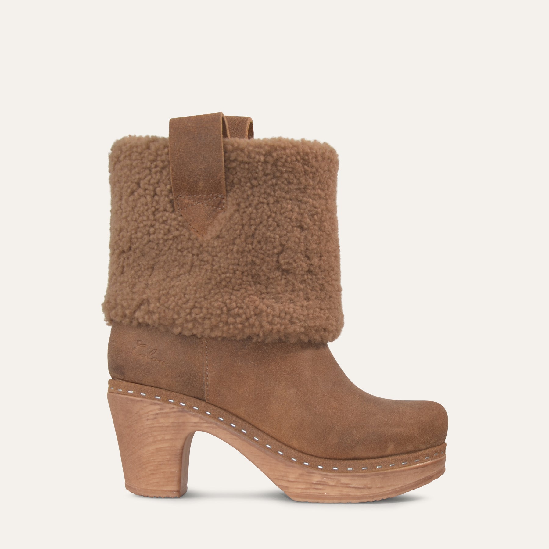 Brown suede boot with shearling collar on a light beige background