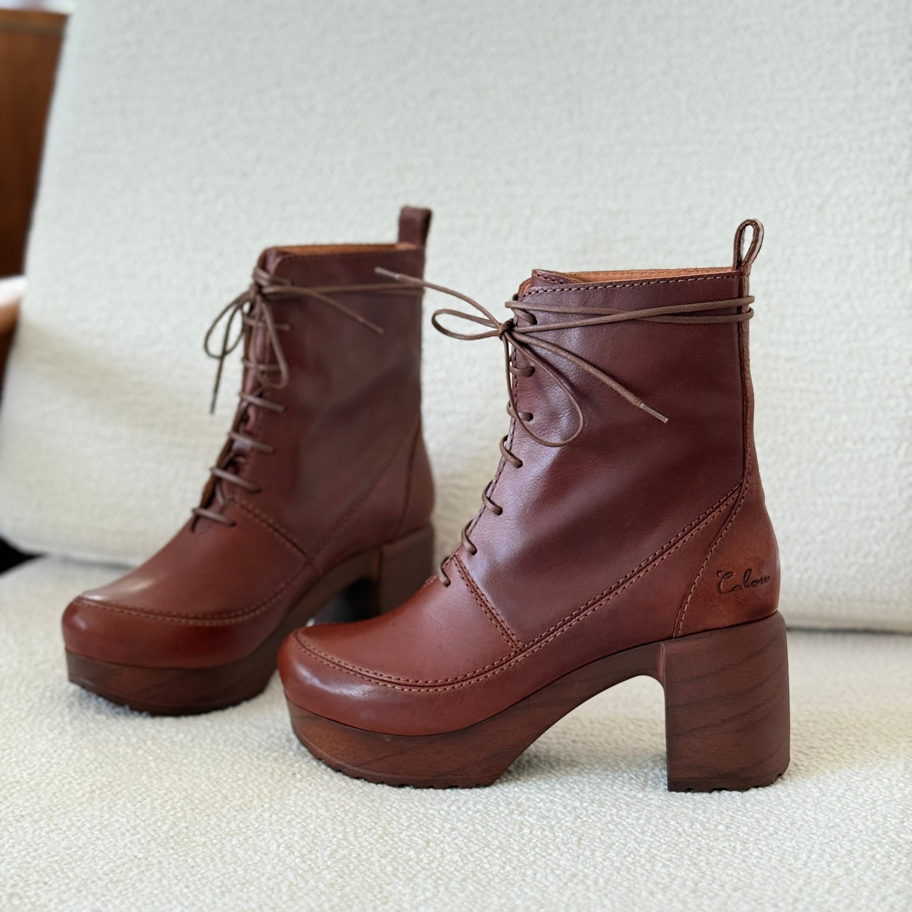 Pair of brown leather boots on a light-colored surface