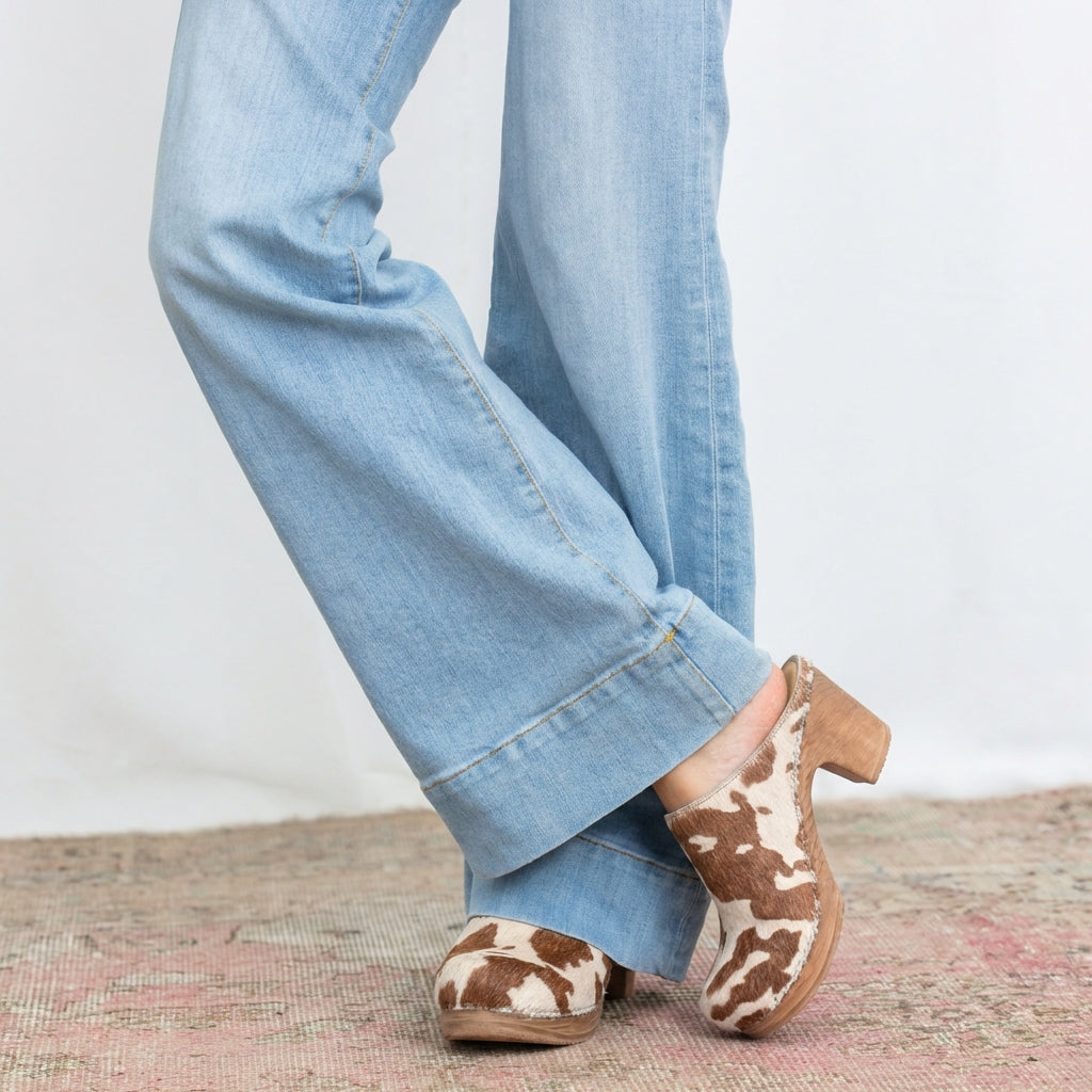 Calou Lisa cowprint ponyskin clogs on soft bendable soles on model