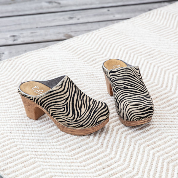 zebra printed leather clog on carpet