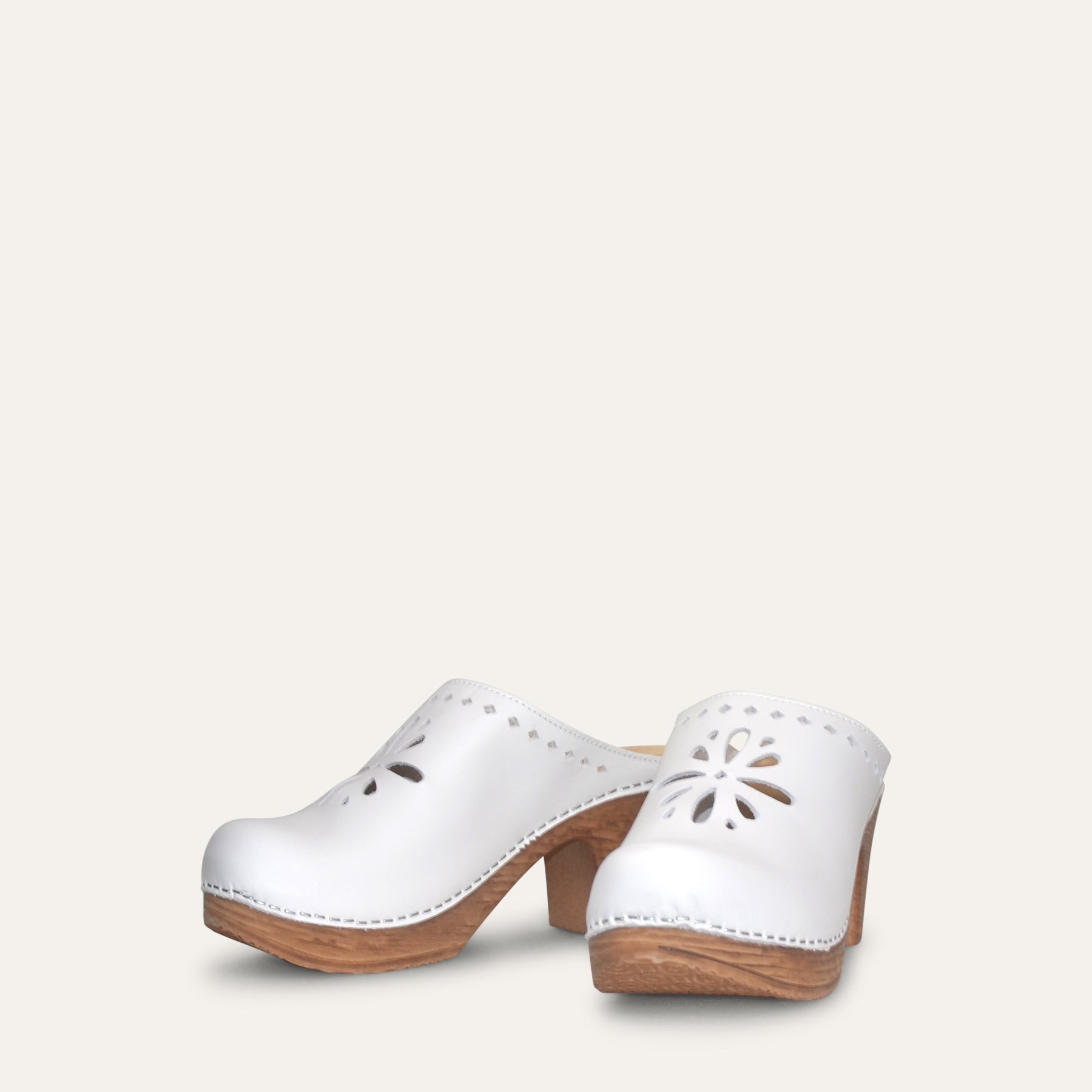 White clog with wood-look heel and flower cut out,  flexible sole by Calou
