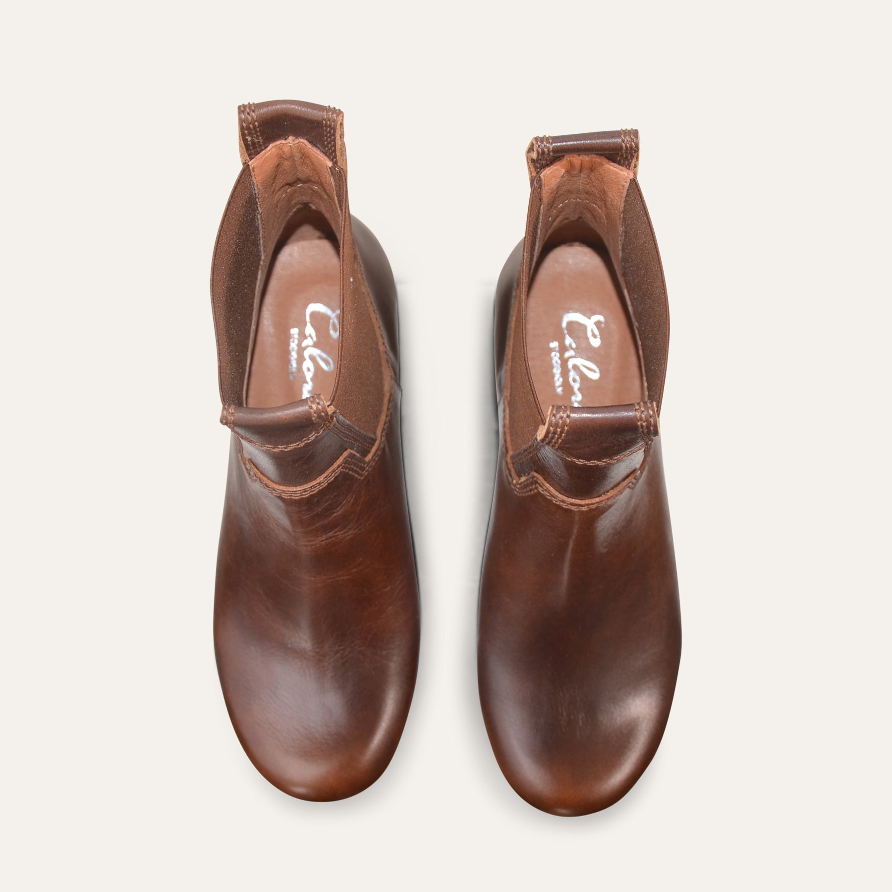 Pair of brown leather boots on a white background