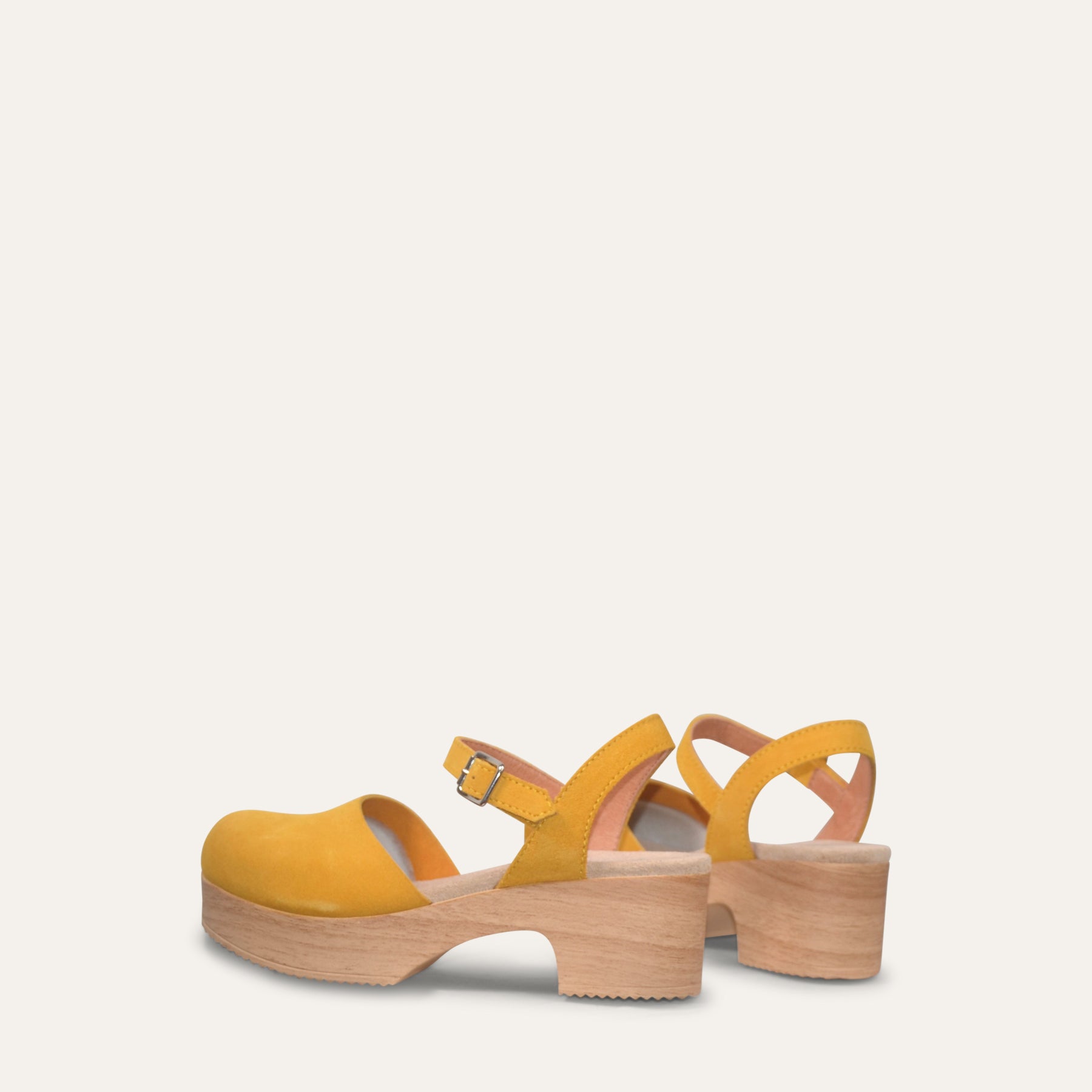 Yellow platform sandals on a light gray background