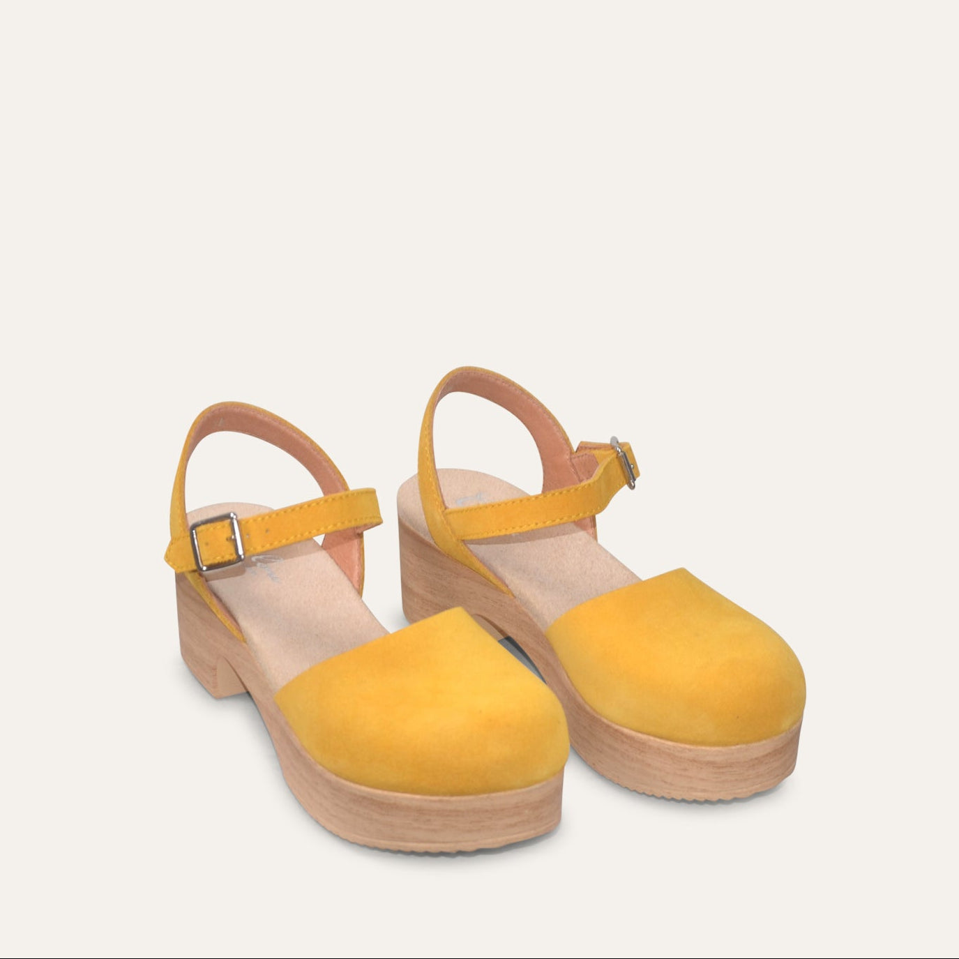 Yellow platform sandals on a light gray background
