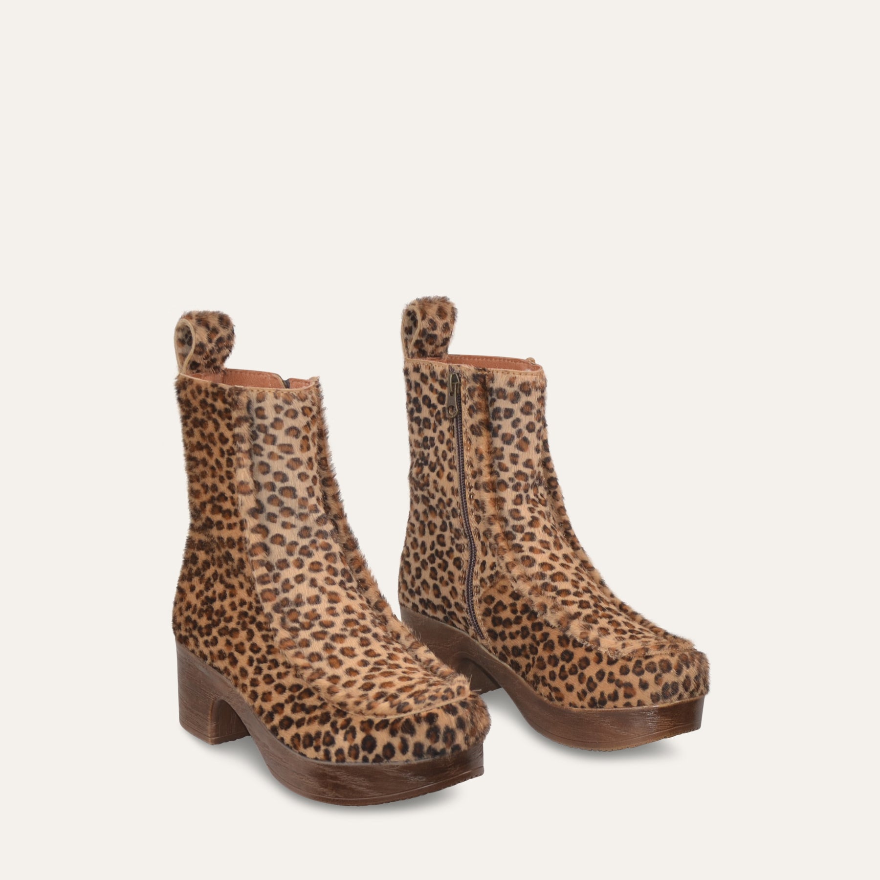 Pair of leopard print boots on a light beige background