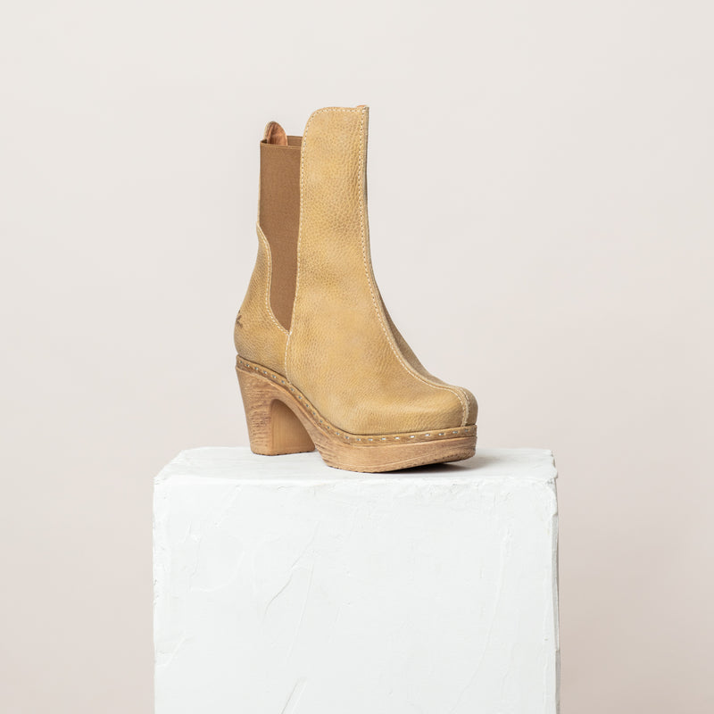 High Beige yellow Clog Boot with slim elasticated shaft on plinth