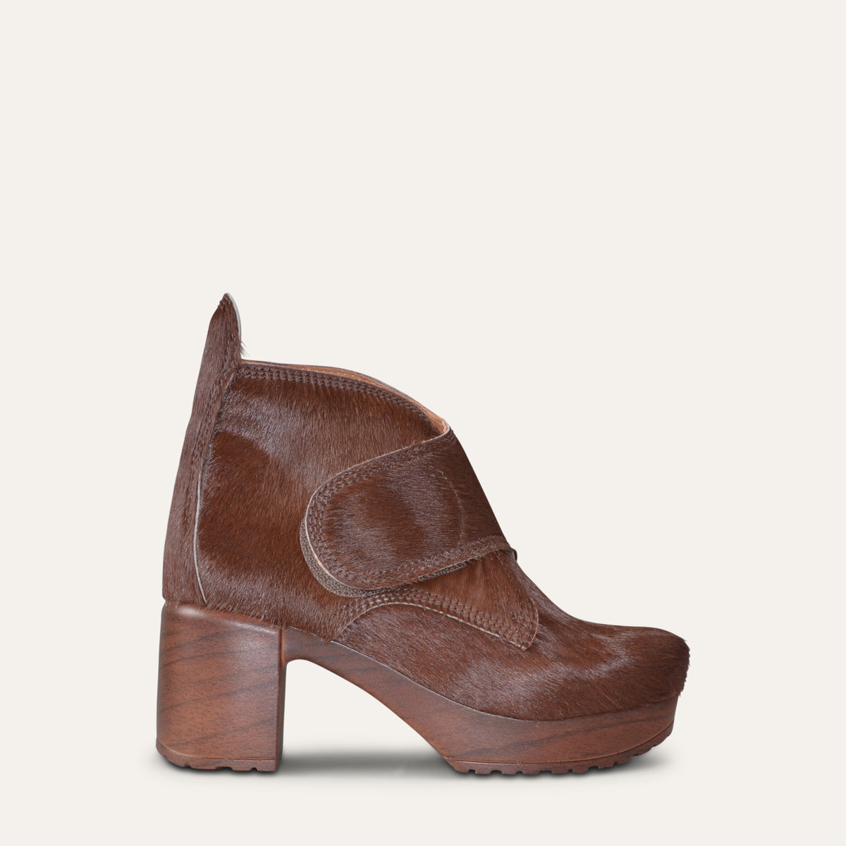Brown pony hair Calou clog boot with hook-and-loop strap and 7.5 cm wooden-look heel, side view