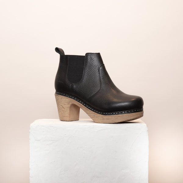 Doris black leather clog boot on plinth