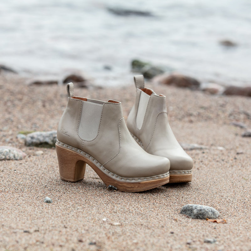 Beige Chelsea high clog boot on sand