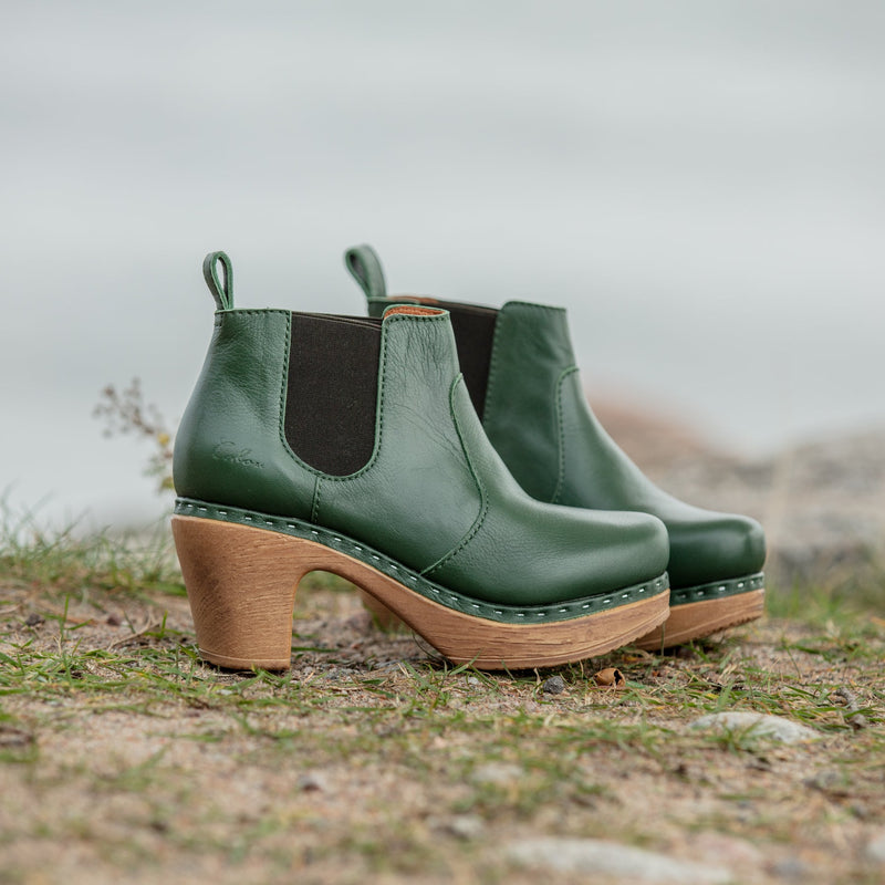 Green leather clogboot in Chelsea style on grass
